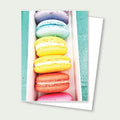 Stack of colorful macarons in pastel shades arranged vertically for a birthday card
