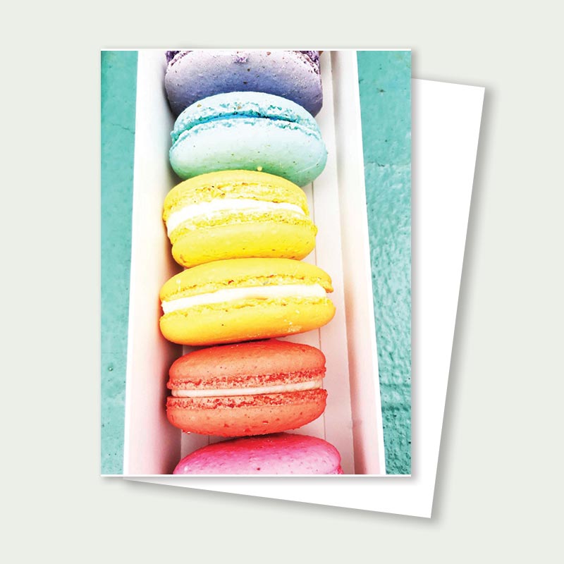 Stack of colorful macarons in pastel shades arranged vertically for a birthday card